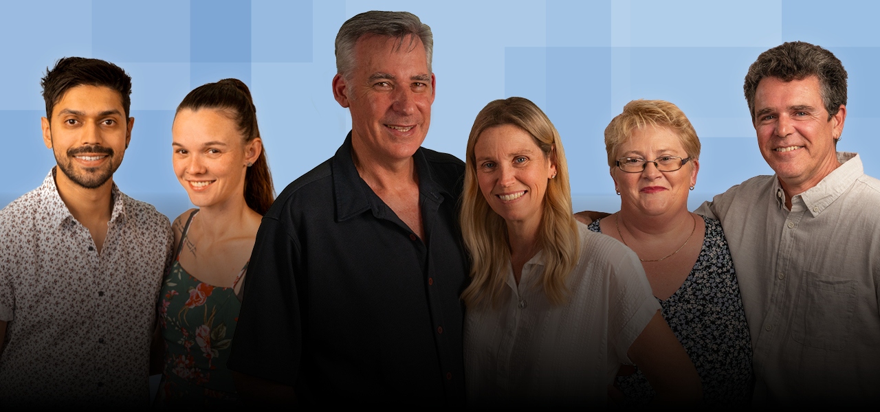 3 couples of different ethnicity smiling and looking at the camera, with a blue background